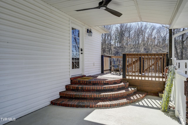 exterior space featuring a deck and a ceiling fan