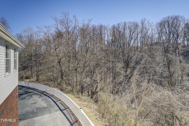 view of road with a wooded view