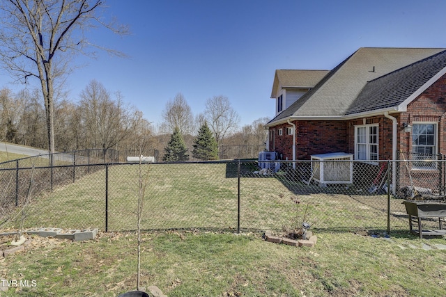 view of yard with central air condition unit and a fenced backyard