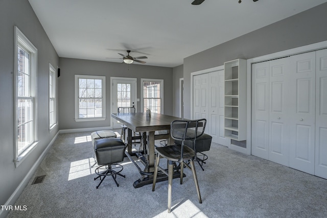 dining room featuring visible vents, carpet flooring, baseboards, and a ceiling fan