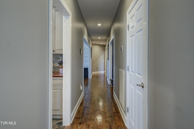 hallway with recessed lighting, baseboards, and dark wood-style floors