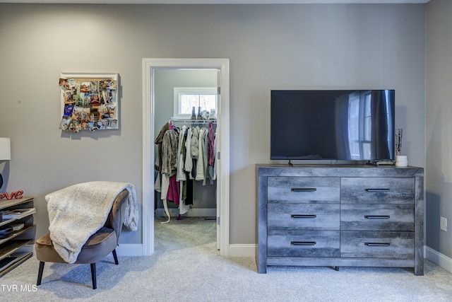 carpeted bedroom featuring a closet, baseboards, and a spacious closet