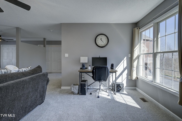 home office featuring visible vents, baseboards, carpet, and ceiling fan