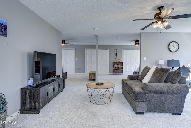 carpeted living area with a textured ceiling