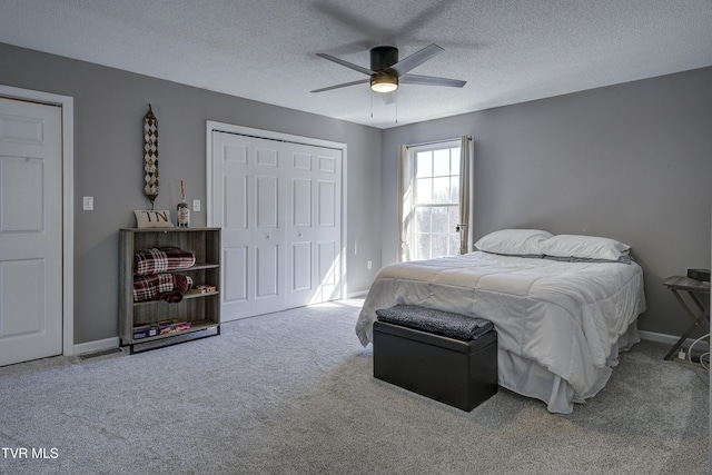 bedroom featuring a closet, a textured ceiling, ceiling fan, and carpet floors