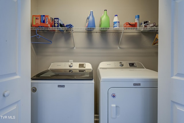 clothes washing area featuring laundry area and washer and dryer