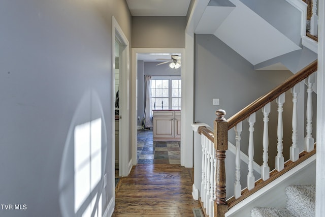 stairway with wood finished floors and visible vents