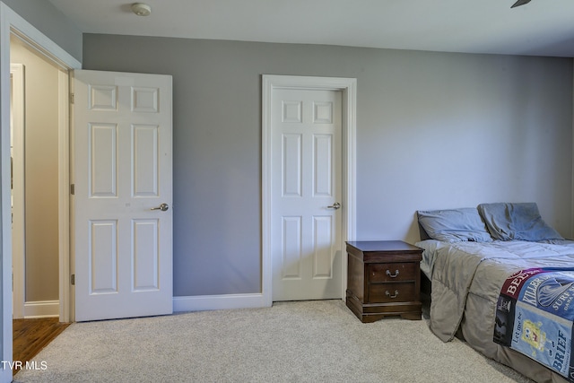 bedroom featuring carpet flooring and baseboards