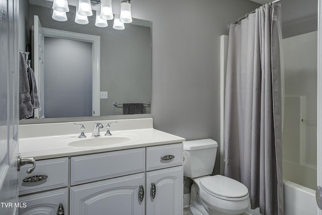 bathroom with vanity, toilet, and shower / bath combo with shower curtain