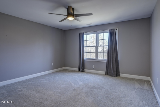 unfurnished room with a ceiling fan, carpet, visible vents, and baseboards