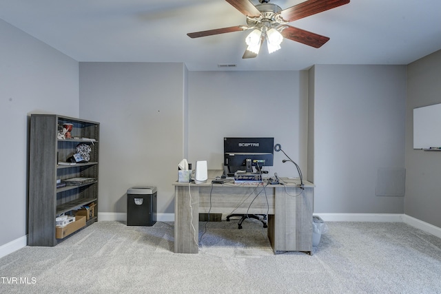 carpeted office space featuring a ceiling fan, baseboards, and visible vents