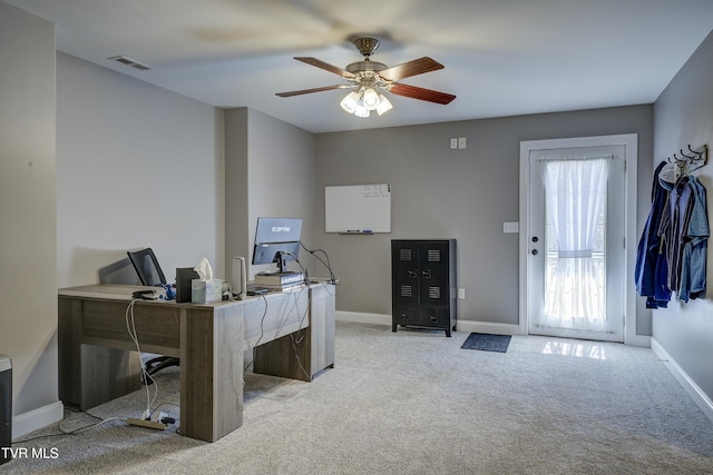 office area featuring visible vents, baseboards, carpet, and ceiling fan