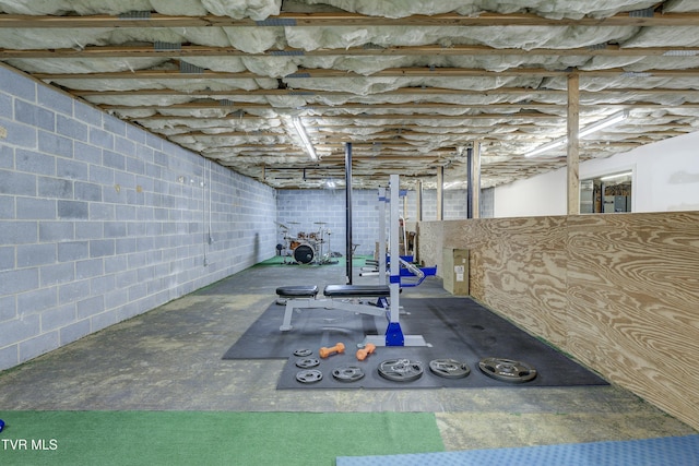 workout area with concrete block wall