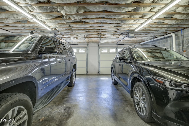 parking garage featuring a garage door opener