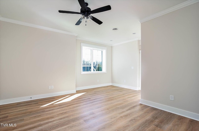 unfurnished room with visible vents, baseboards, light wood-style flooring, ceiling fan, and ornamental molding