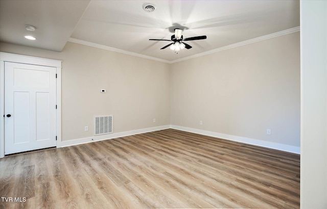 unfurnished room with visible vents, baseboards, and wood finished floors