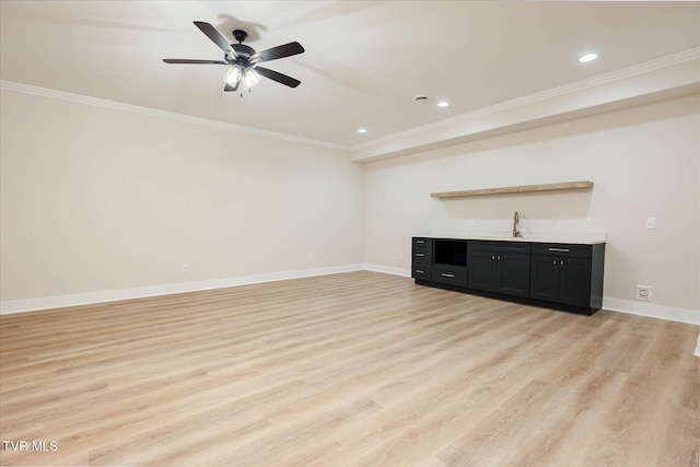 unfurnished living room with light wood finished floors, baseboards, and ornamental molding