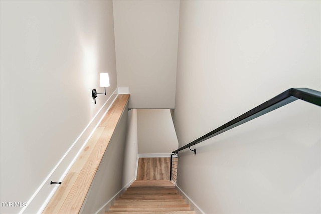 stairway with wood finished floors