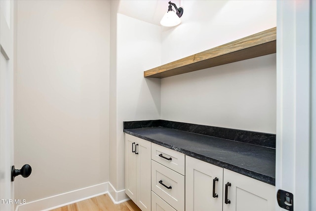 interior space featuring baseboards and wood finished floors