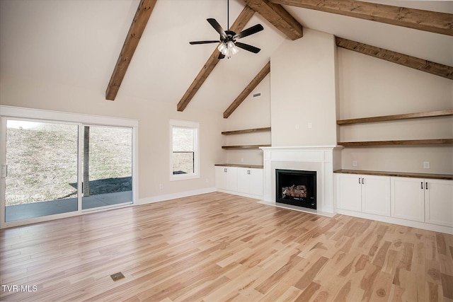 unfurnished living room featuring a ceiling fan, a fireplace with flush hearth, light wood-style flooring, high vaulted ceiling, and beam ceiling