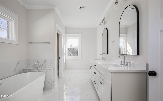 full bathroom with a freestanding bath, marble finish floor, a sink, and crown molding