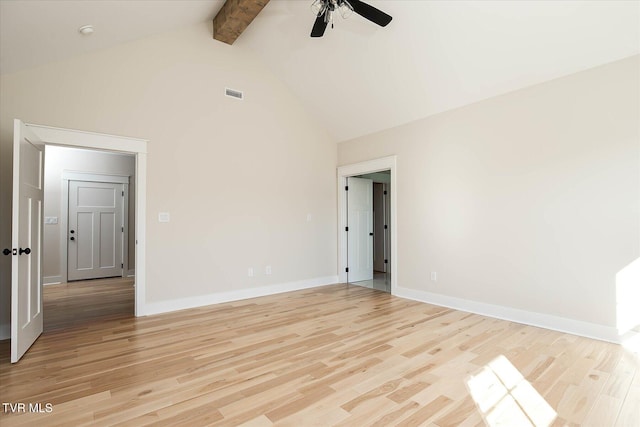 empty room featuring visible vents, baseboards, light wood-style flooring, high vaulted ceiling, and beam ceiling