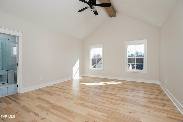 spare room featuring vaulted ceiling with beams, light wood finished floors, and ceiling fan