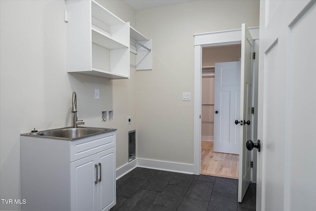 laundry room featuring cabinet space, baseboards, electric dryer hookup, washer hookup, and a sink