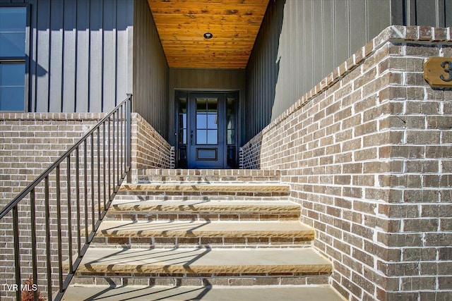 entrance to property featuring brick siding