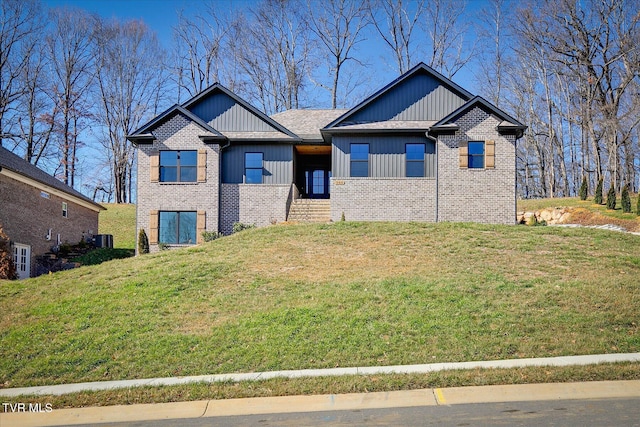 view of front facade featuring brick siding and a front lawn