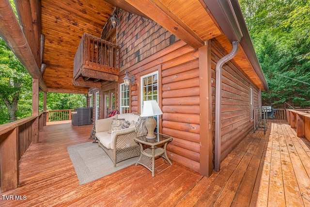 wooden terrace with an outdoor hangout area