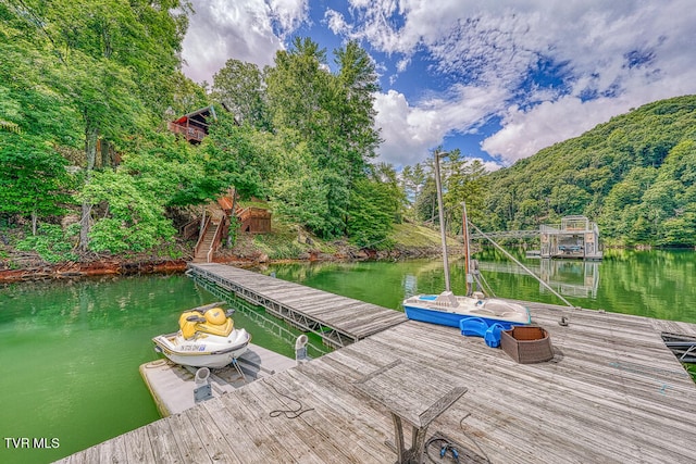 dock area with a water view and stairs