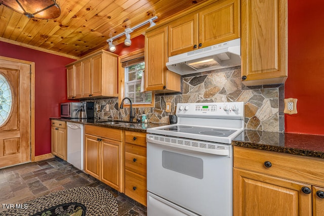 kitchen with dishwashing machine, under cabinet range hood, electric stove, stone finish floor, and dark stone countertops