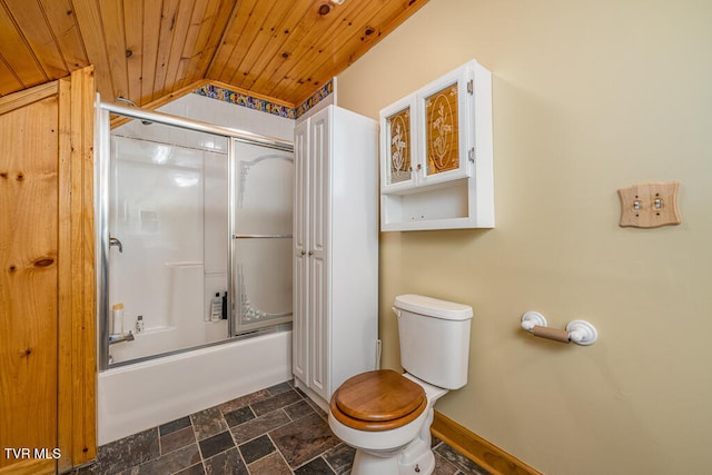 bathroom with toilet, stone finish floor, combined bath / shower with glass door, wooden ceiling, and baseboards