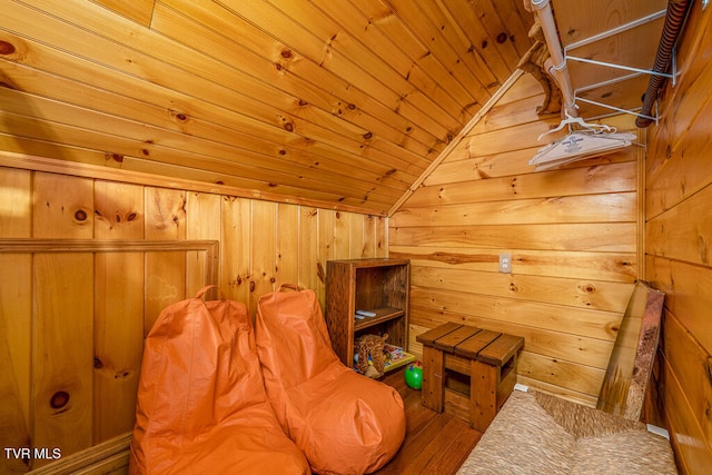 sitting room featuring lofted ceiling, wood ceiling, wood walls, and a sauna