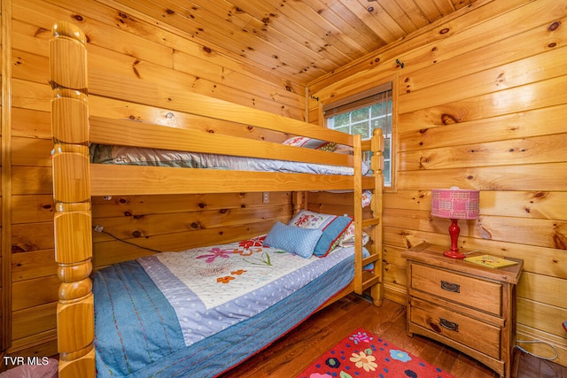 bedroom featuring wooden ceiling, wooden walls, and wood finished floors