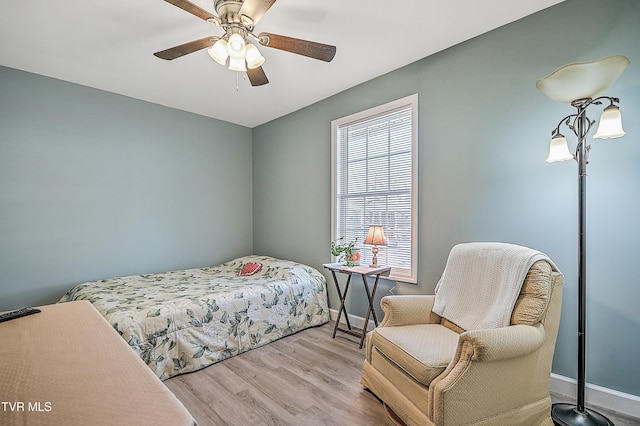 bedroom featuring ceiling fan, wood finished floors, and baseboards