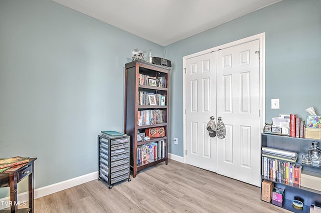 interior space featuring wood finished floors and baseboards