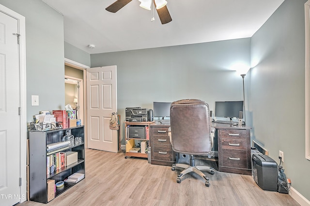 office space featuring ceiling fan, baseboards, and wood finished floors