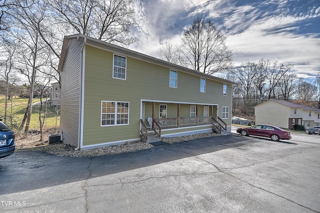 view of front of house with a porch and central AC unit