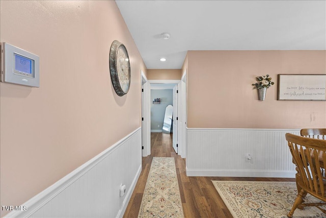 hall with recessed lighting, wainscoting, and wood finished floors