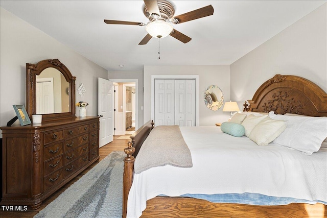 bedroom featuring a closet, wood finished floors, and a ceiling fan