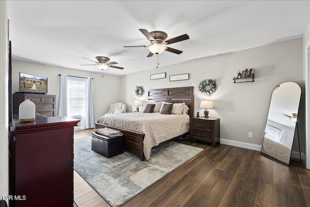 bedroom with a ceiling fan, dark wood-style flooring, and baseboards