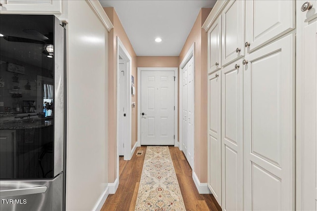 entryway featuring baseboards, wood finished floors, and recessed lighting