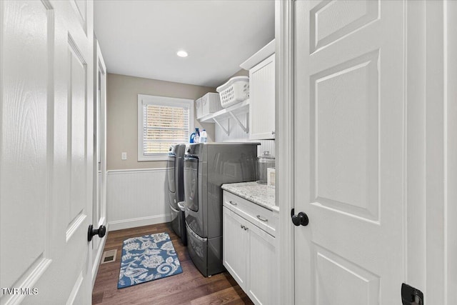 laundry area featuring a wainscoted wall, dark wood finished floors, recessed lighting, visible vents, and independent washer and dryer