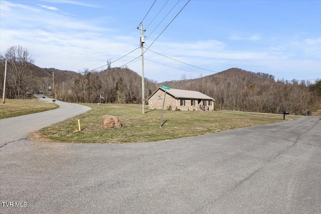 view of road with a mountain view and a forest view