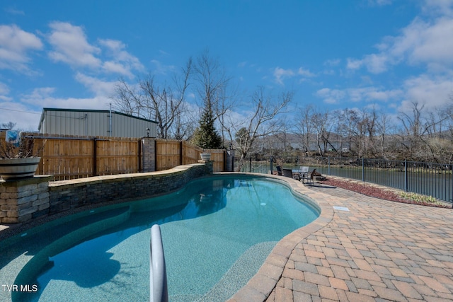 view of pool featuring a patio area, a fenced backyard, and a fenced in pool