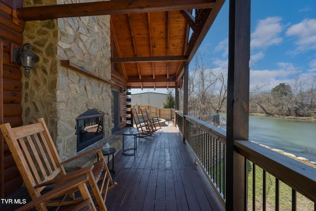 wooden terrace featuring a water view