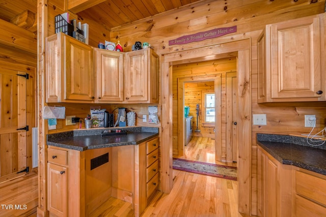 kitchen with light wood-style floors, wood ceiling, wooden walls, and light brown cabinetry