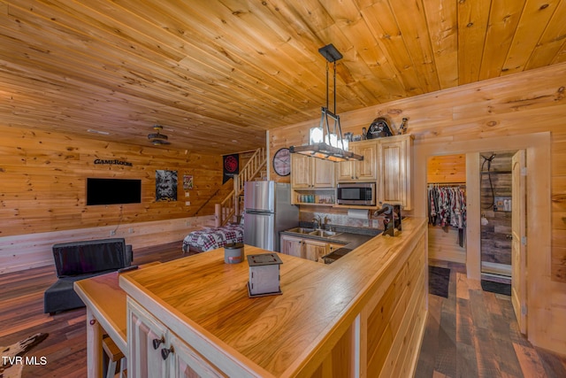 kitchen featuring stainless steel appliances, butcher block counters, wooden ceiling, and wooden walls